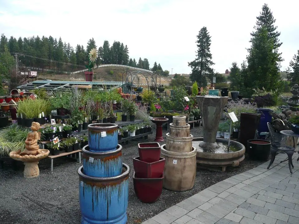Display of tiered garden fountains in blue and neutral-colored pots