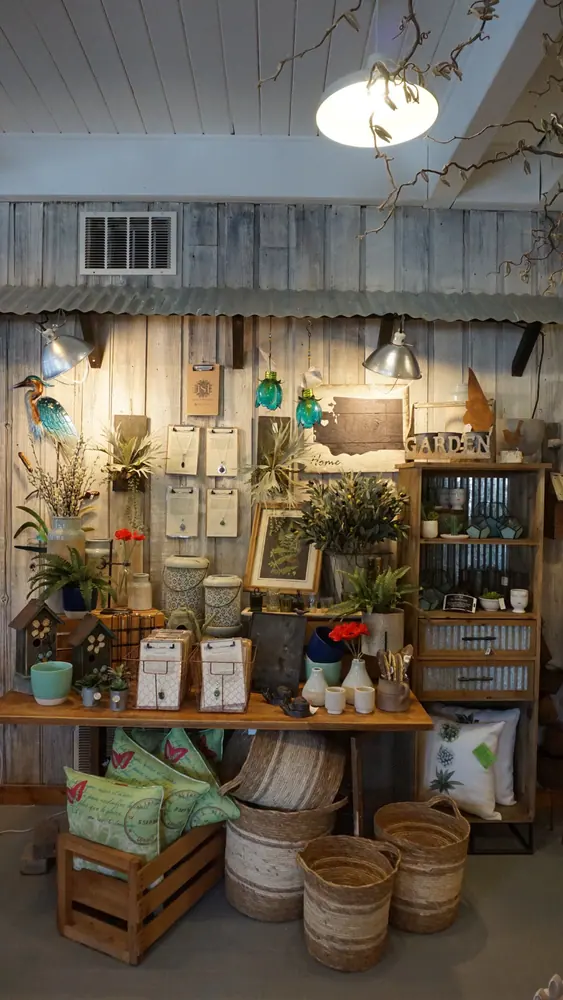 Shop display of hanging wind chimes, baskets and garden gifts